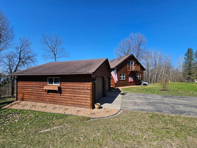 19319 Elsie Way NW, Bemidji, MN 56601 - view of side of property with faux log siding and a lawn
