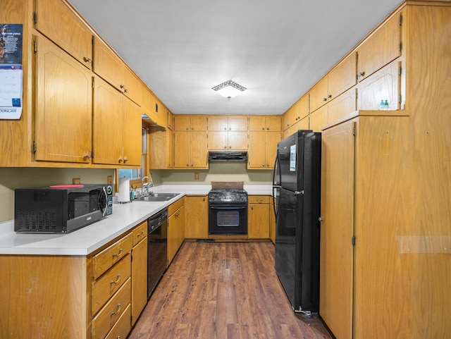 1716 9th Ave SE, Saint Cloud, MN 56304 - kitchen featuring black appliances, under cabinet range hood, a sink, dark wood-type flooring, and light countertops