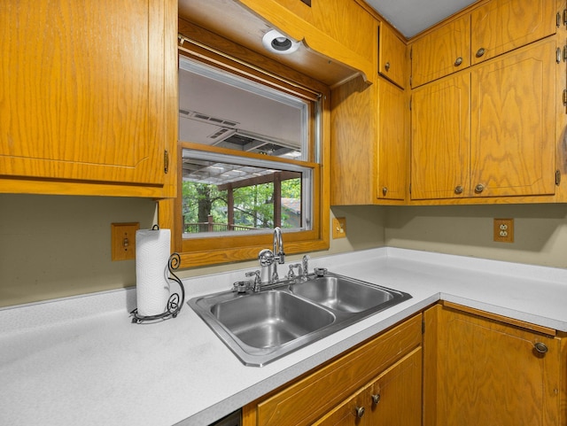 1716 9th Ave SE, Saint Cloud, MN 56304 - kitchen featuring a sink, light countertops, and brown cabinets