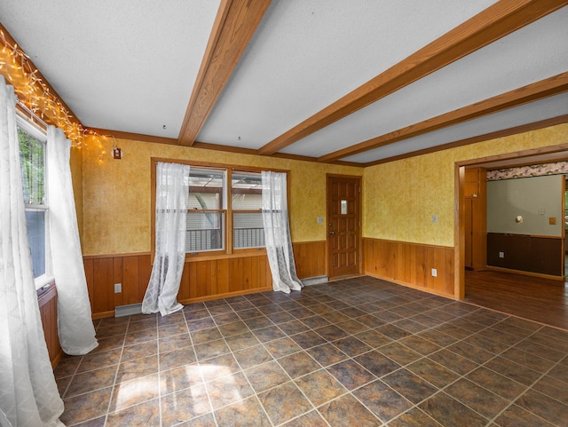 1716 9th Ave SE, Saint Cloud, MN 56304 - empty room with wainscoting, beam ceiling, and wood walls