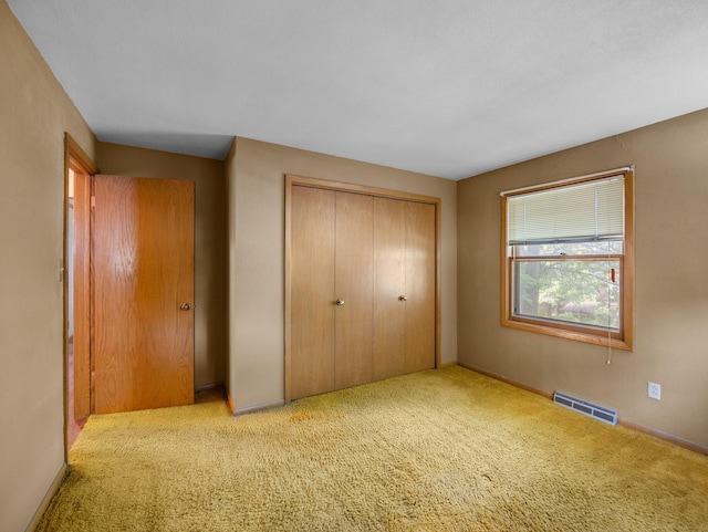 1716 9th Ave SE, Saint Cloud, MN 56304 - unfurnished bedroom featuring a closet and carpet