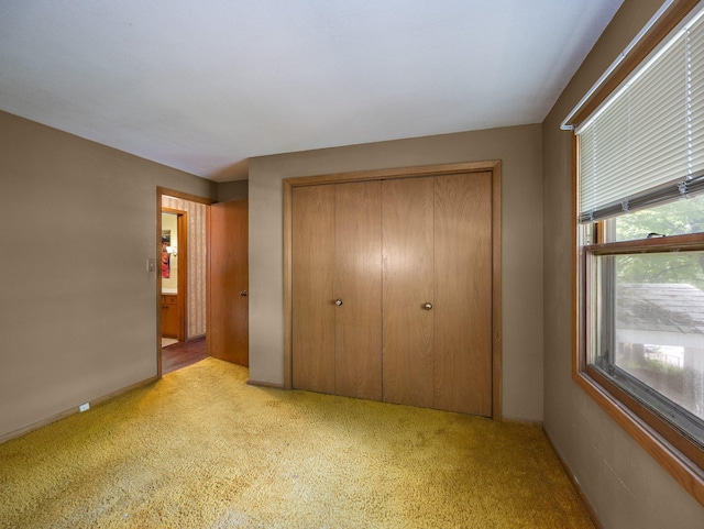 1716 9th Ave SE, Saint Cloud, MN 56304 - unfurnished bedroom with light colored carpet, a closet, and baseboards