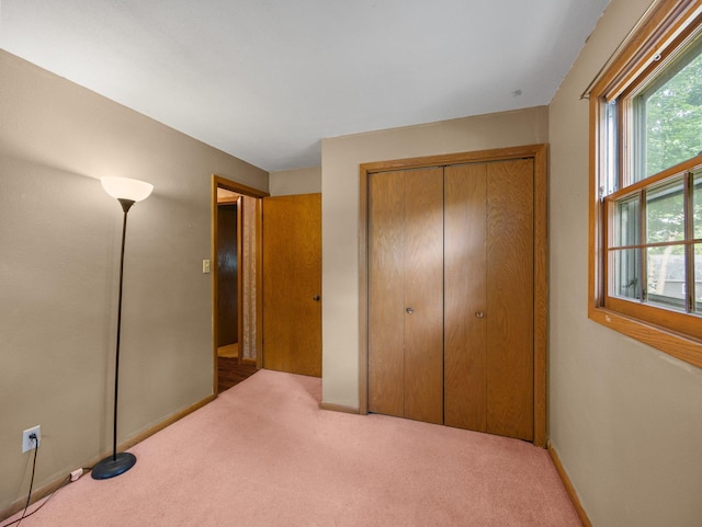 1716 9th Ave SE, Saint Cloud, MN 56304 - unfurnished bedroom featuring carpet floors, a closet, and baseboards