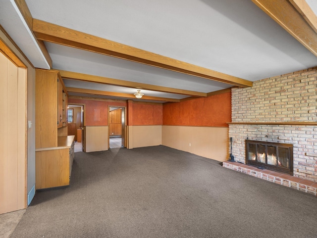 1716 9th Ave SE, Saint Cloud, MN 56304 - unfurnished living room featuring beamed ceiling, dark carpet, and a fireplace