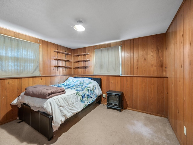 1716 9th Ave SE, Saint Cloud, MN 56304 - bedroom with wooden walls, carpet flooring, and a wood stove