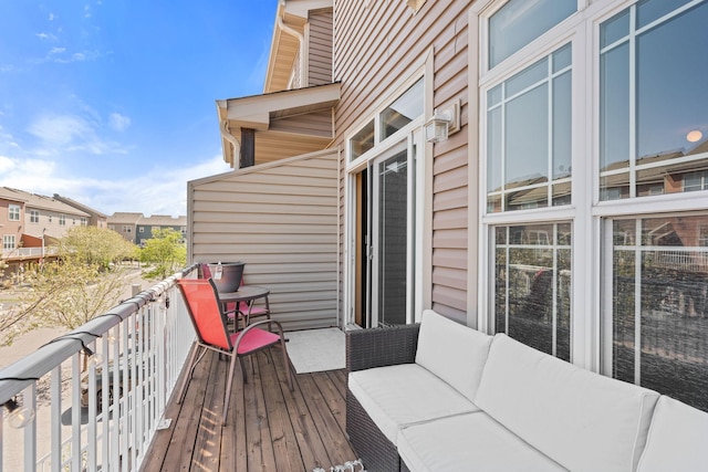 wooden deck with outdoor lounge area and a residential view