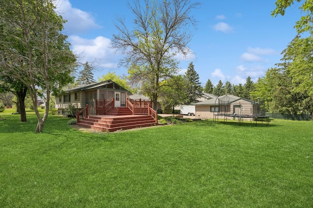 14129 Quay St NW, Andover, MN 55304 - view of grassy yard with a trampoline and a wooden deck