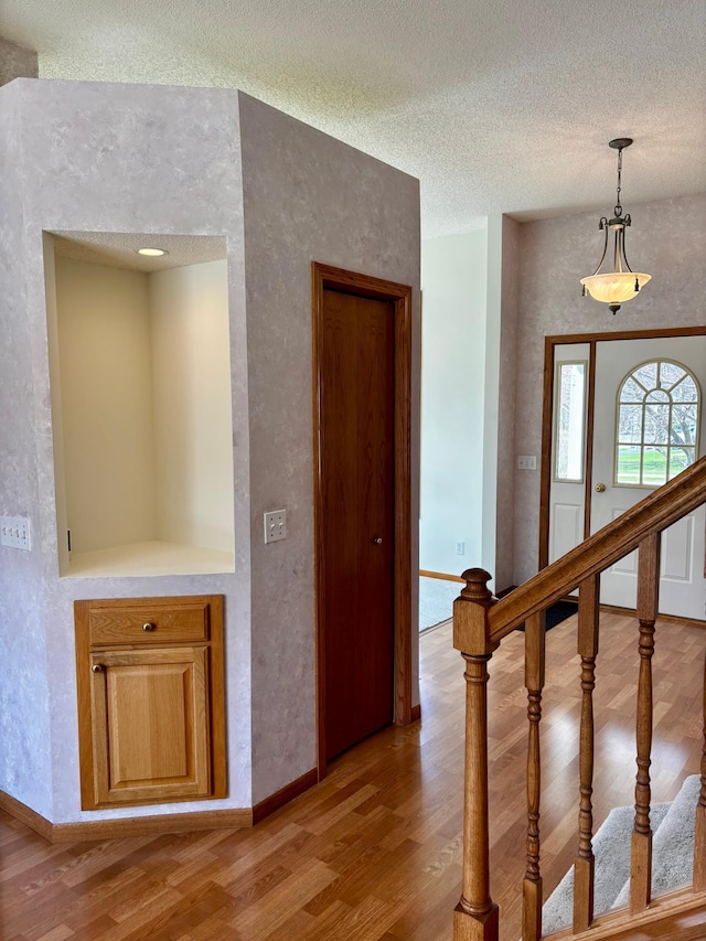 13852 Jasmine Way, Rogers, MN 55374 - hall featuring light wood finished floors, a textured ceiling, and baseboards