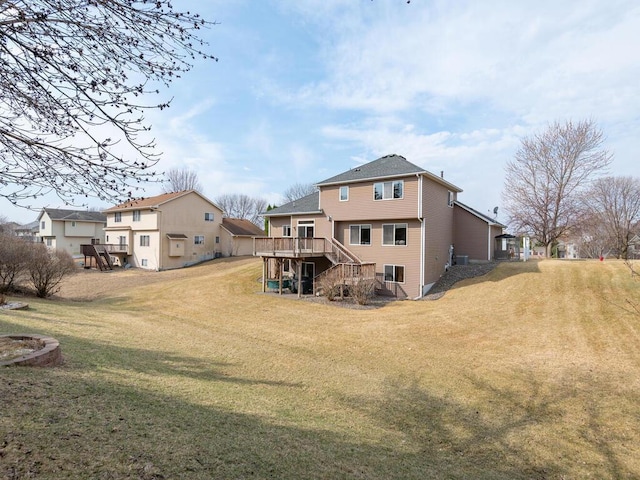 13852 Jasmine Way, Rogers, MN 55374 - back of property with stairway, a wooden deck, and a yard
