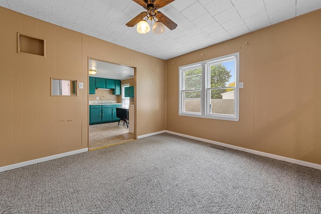 108 Benjamin St, Jackson, MN 56143 - unfurnished room featuring ceiling fan, light carpet, a sink, and baseboards