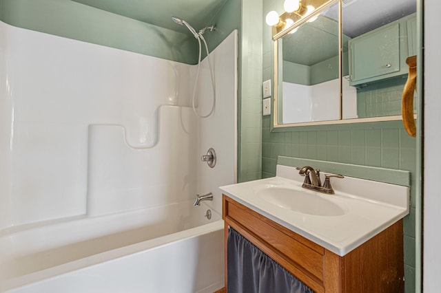 108 Benjamin St, Jackson, MN 56143 - bathroom featuring washtub / shower combination, vanity, and tile walls