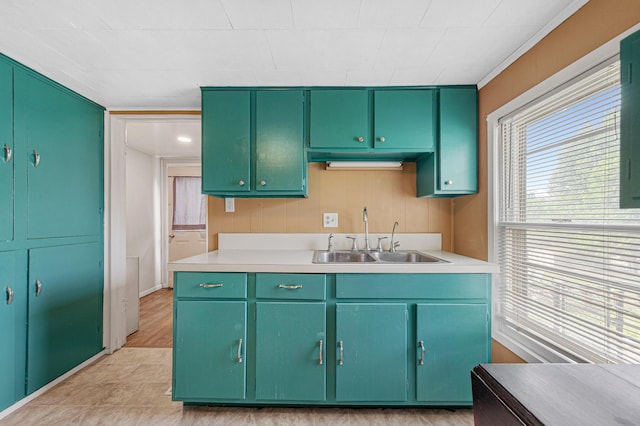 108 Benjamin St, Jackson, MN 56143 - kitchen with a sink, light countertops, and a decorative wall