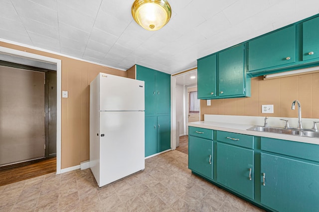 108 Benjamin St, Jackson, MN 56143 - kitchen with freestanding refrigerator, a sink, light countertops, and baseboards