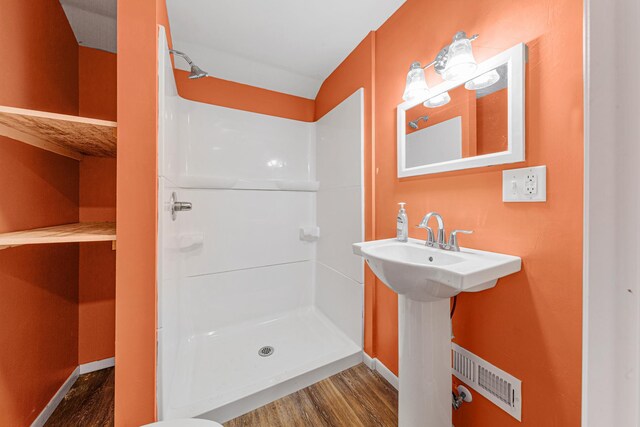 108 Benjamin St, Jackson, MN 56143 - full bath featuring wood finished floors, a stall shower, and baseboards
