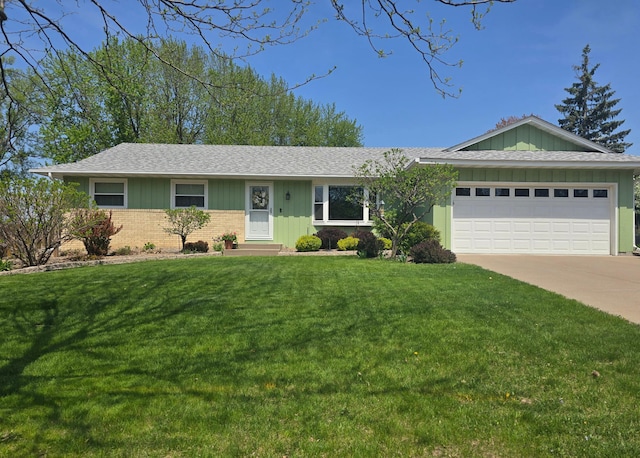 single story home with board and batten siding, an attached garage, a front lawn, driveway, and brick siding
