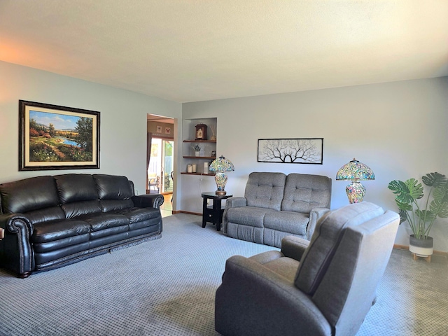 carpeted living room featuring baseboards and built in shelves