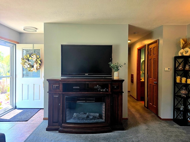 living room featuring a textured ceiling and baseboards
