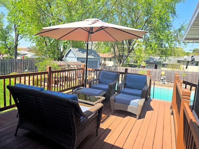 deck featuring a fenced backyard, outdoor lounge area, an outbuilding, and a shed