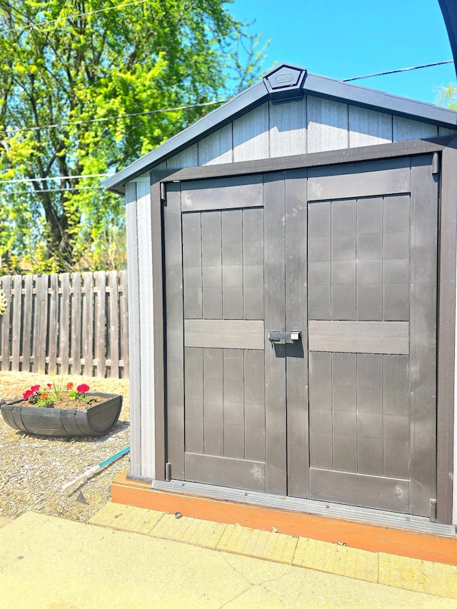 view of shed featuring fence