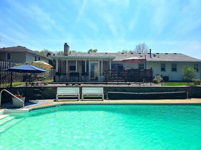 outdoor pool featuring fence and a patio