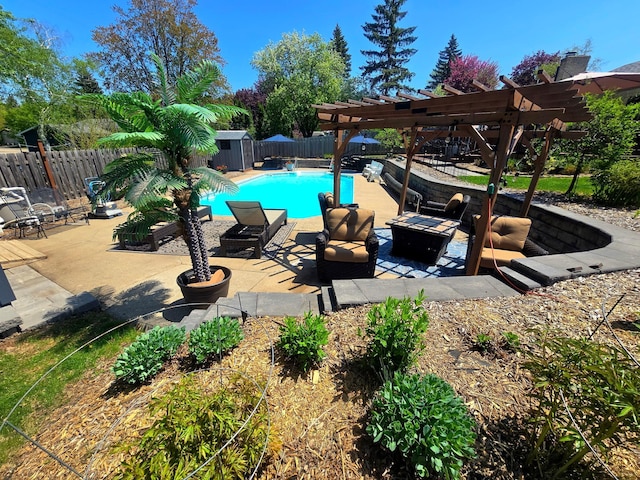 view of swimming pool featuring a shed, a fire pit, a fenced backyard, a pergola, and an outbuilding