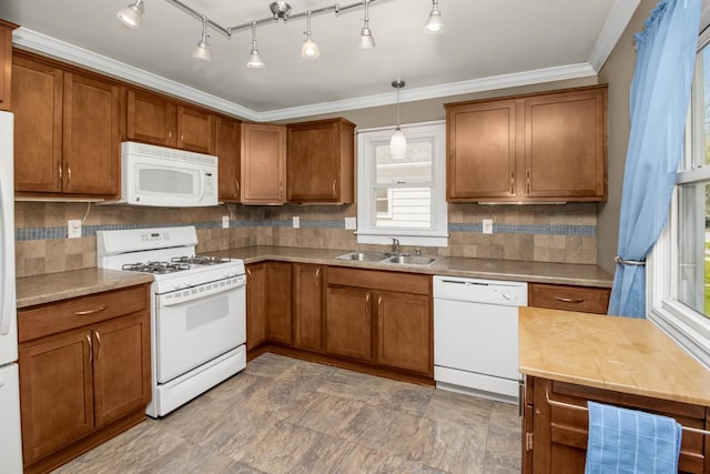 kitchen with white appliances, a sink, brown cabinets, decorative backsplash, and ornamental molding
