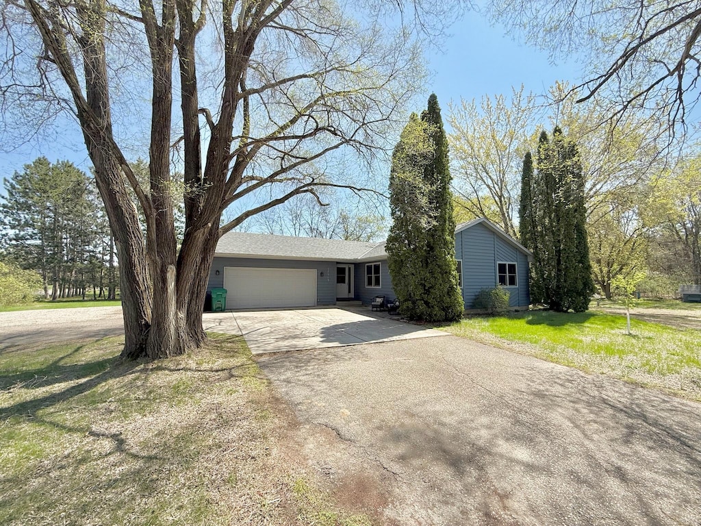 ranch-style home with an attached garage and driveway