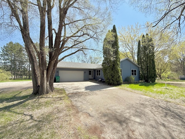 ranch-style home with an attached garage and driveway