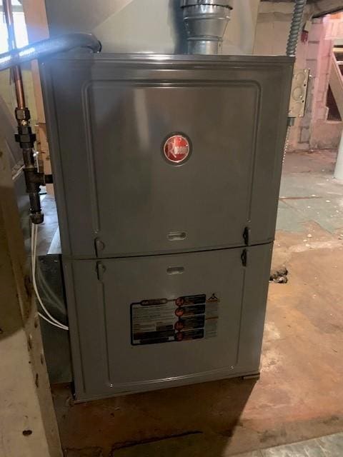 utility room featuring heating unit