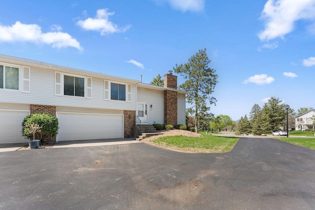1635 140th St, Burnsville, MN 55337 - bi-level home with brick siding, a chimney, and driveway