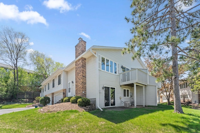1635 140th St, Burnsville, MN 55337 - view of side of property featuring a chimney, a lawn, and central AC unit
