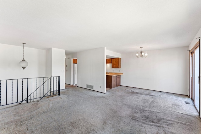 1635 140th St, Burnsville, MN 55337 - unfurnished room with a chandelier and light colored carpet