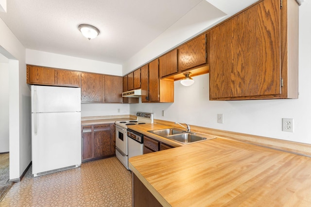 1635 140th St, Burnsville, MN 55337 - kitchen with white appliances, a sink, light countertops, brown cabinets, and under cabinet range hood