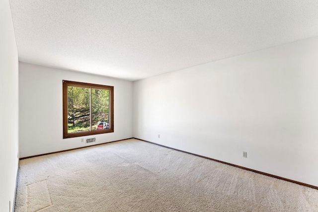 1635 140th St, Burnsville, MN 55337 - unfurnished room featuring carpet, a textured ceiling, and baseboards