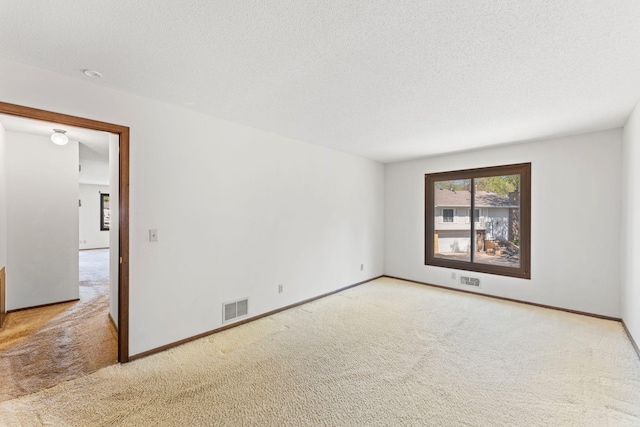 1635 140th St, Burnsville, MN 55337 - carpeted spare room featuring a textured ceiling and baseboards