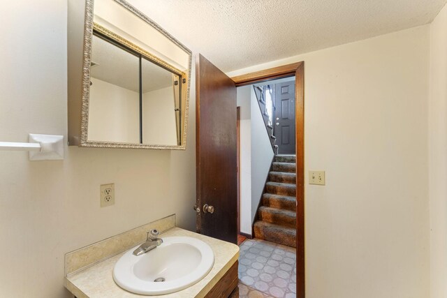 1635 140th St, Burnsville, MN 55337 - bathroom featuring vanity, tile patterned floors, and a textured ceiling
