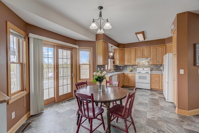 347 Glover Rd, Troy Twp, WI 54022 - dining room with a chandelier, baseboards, and stone finish flooring
