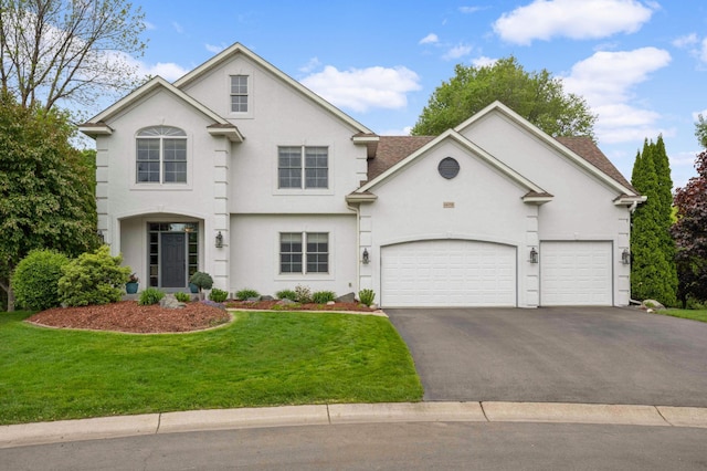 14058 Haas Lake Cir NW, Prior Lake, MN 55372 - view of front of home featuring asphalt driveway, stucco siding, a front lawn, and a garage