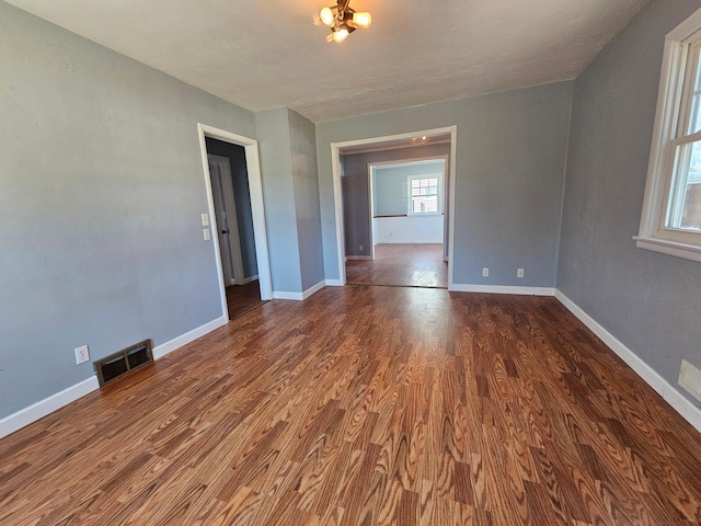 spare room featuring wood finished floors and baseboards