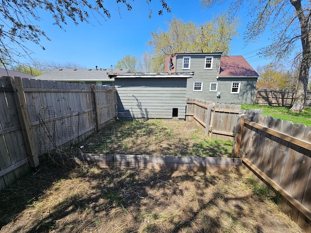 back of house with a fenced backyard