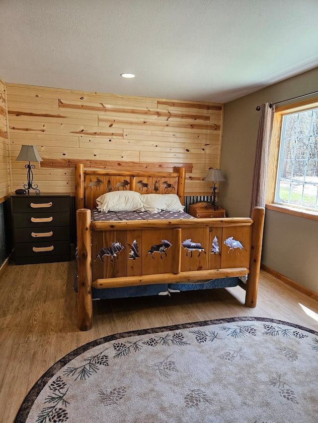 36282 Rush Lake Loop Unit 29A, Ottertail, MN 56571 - bedroom featuring wood finished floors, wooden walls, and baseboards