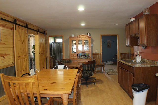36282 Rush Lake Loop Unit 29A, Ottertail, MN 56571 - dining space with a barn door, light wood-style floors, and recessed lighting