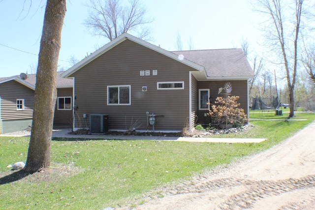 36282 Rush Lake Loop Unit 29A, Ottertail, MN 56571 - view of home's exterior with a lawn, cooling unit, and roof with shingles