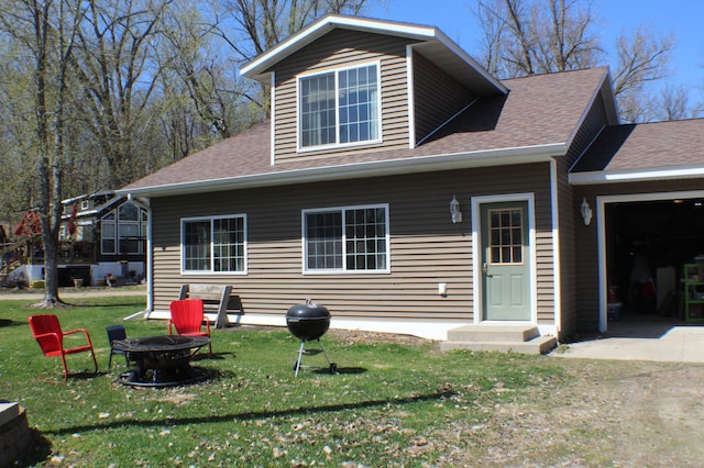 36282 Rush Lake Loop Unit 29A, Ottertail, MN 56571 - back of property featuring a fire pit, a lawn, a garage, and a shingled roof
