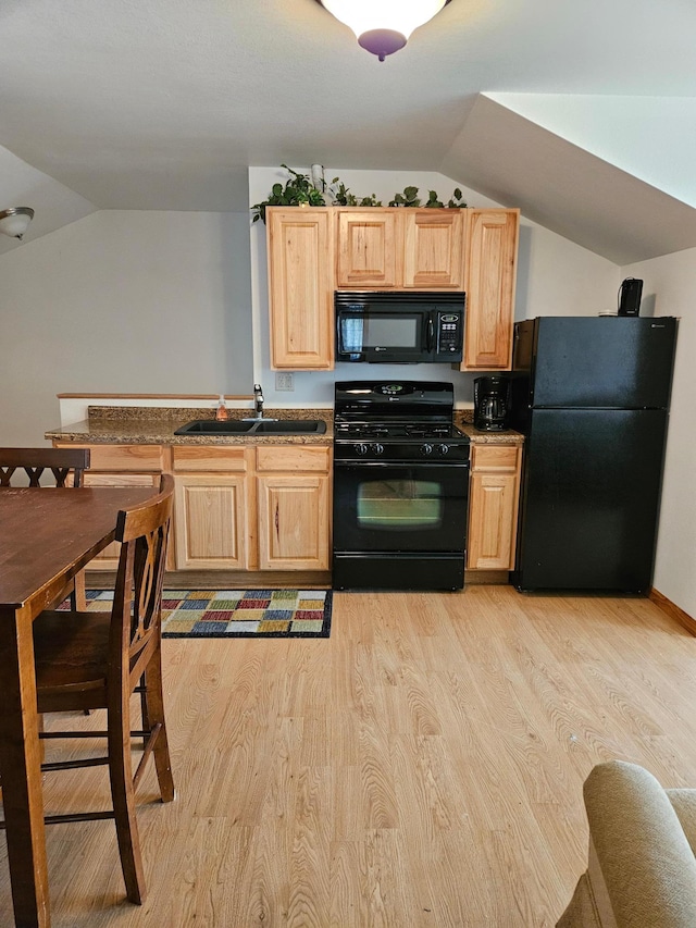 36282 Rush Lake Loop Unit 29A, Ottertail, MN 56571 - kitchen with black appliances, a sink, vaulted ceiling, light wood finished floors, and light brown cabinetry
