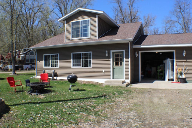 36282 Rush Lake Loop Unit 29A, Ottertail, MN 56571 - back of property featuring a fire pit, a lawn, an attached garage, and roof with shingles