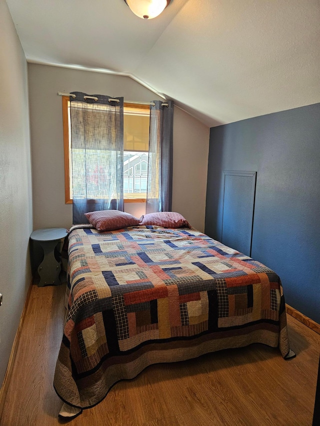 36282 Rush Lake Loop Unit 29A, Ottertail, MN 56571 - bedroom featuring wood finished floors, lofted ceiling, and baseboards