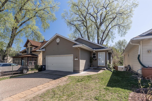 view of front of property featuring driveway, a garage, and a front lawn
