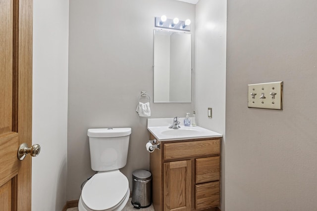 half bathroom with vanity and toilet