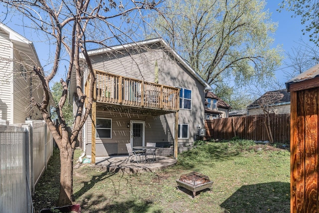 rear view of house featuring a fire pit, a patio area, and a wooden deck